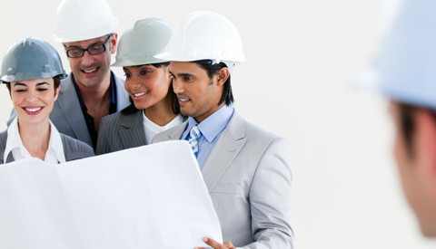 Group in hard hats reviewing drawings